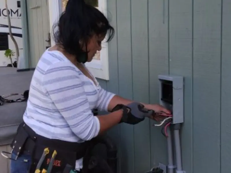 Licensed electrician wiring an exterior subpanel in Vevay
